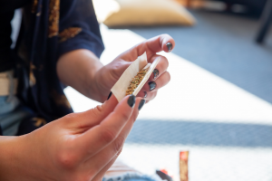 A woman rolling a joint