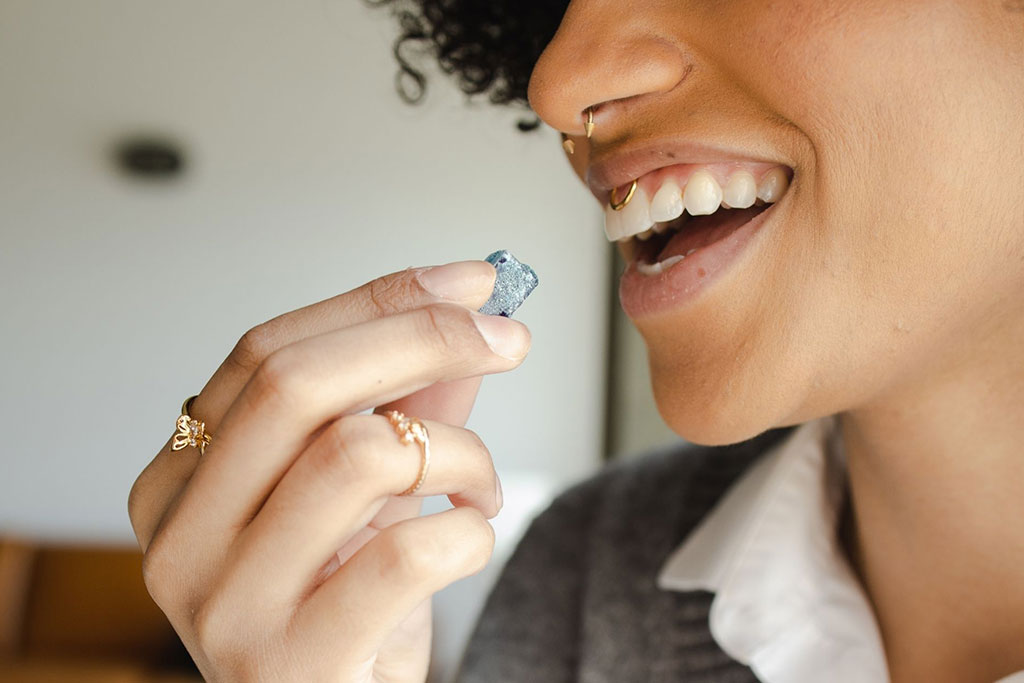 A woman about to eat a cannabis gummy