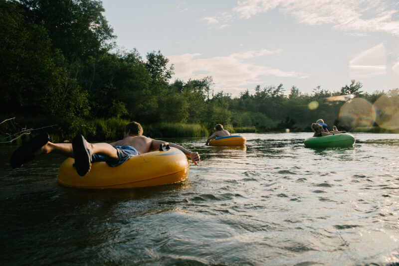 a group of people floating on tubes in a river in Ontario