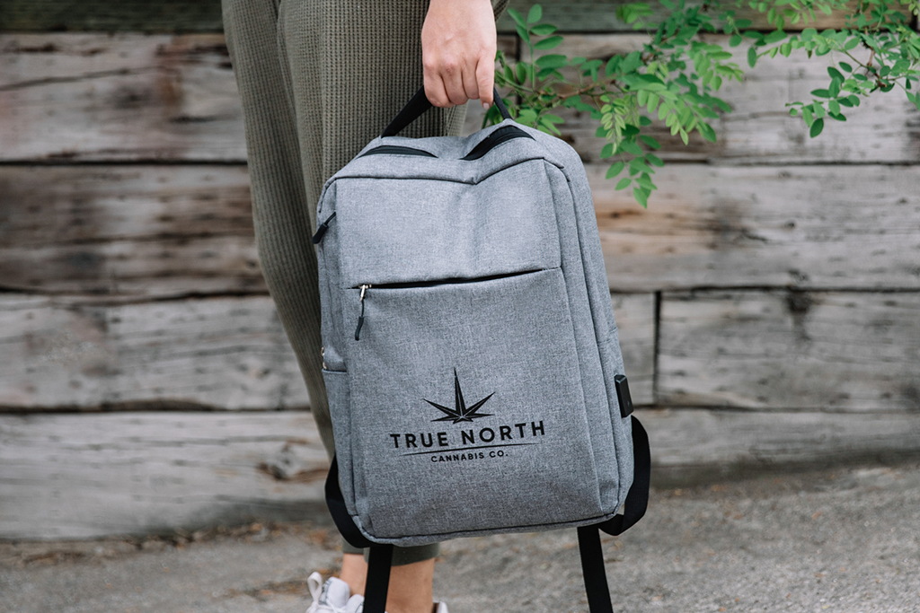 a person holding a True North Cannabis Co. branded backpack on a day trip in Cambridge, Ontario