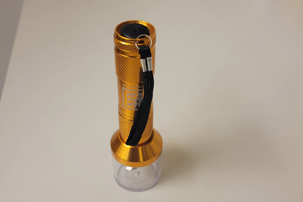 A bamboo blaze electric flashlight grinder in gold