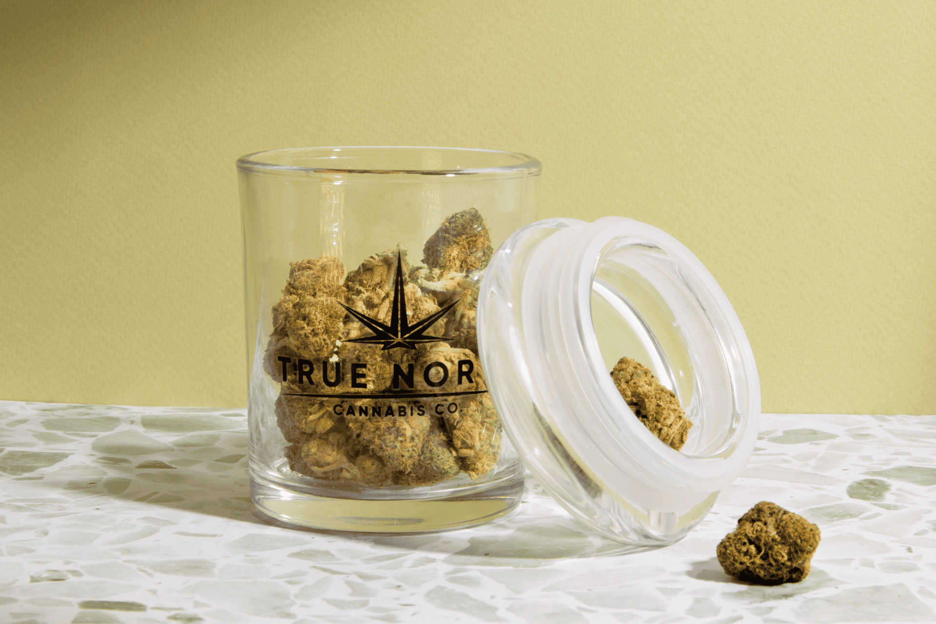 A True North Cannabis Co. stash jar filled with cannabis buds