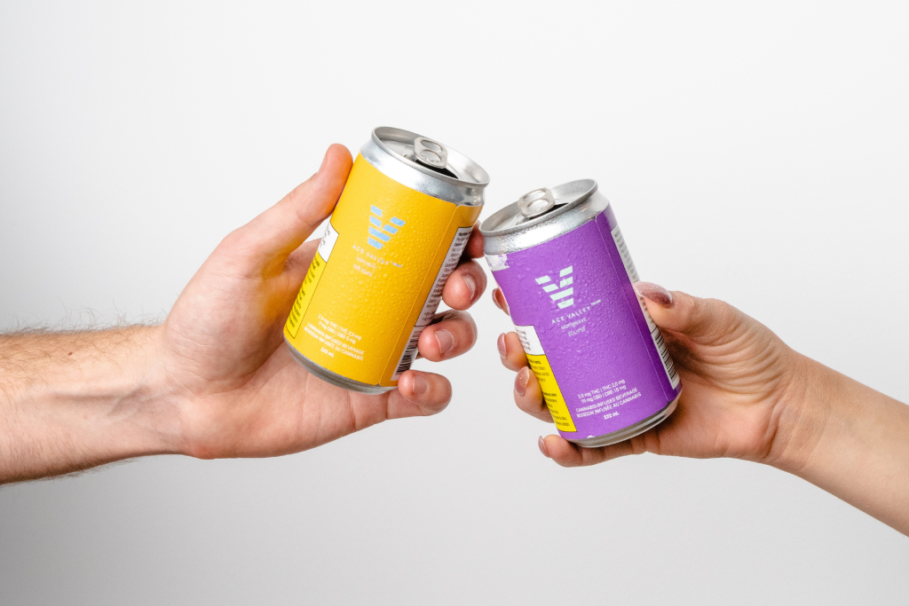  two people cheers with cannabis-infused beverages 