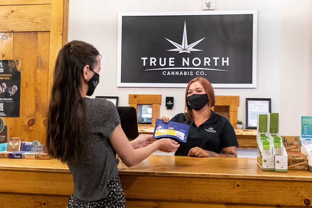 A customer supporting local businesses by shopping at True North Cannabis Co.