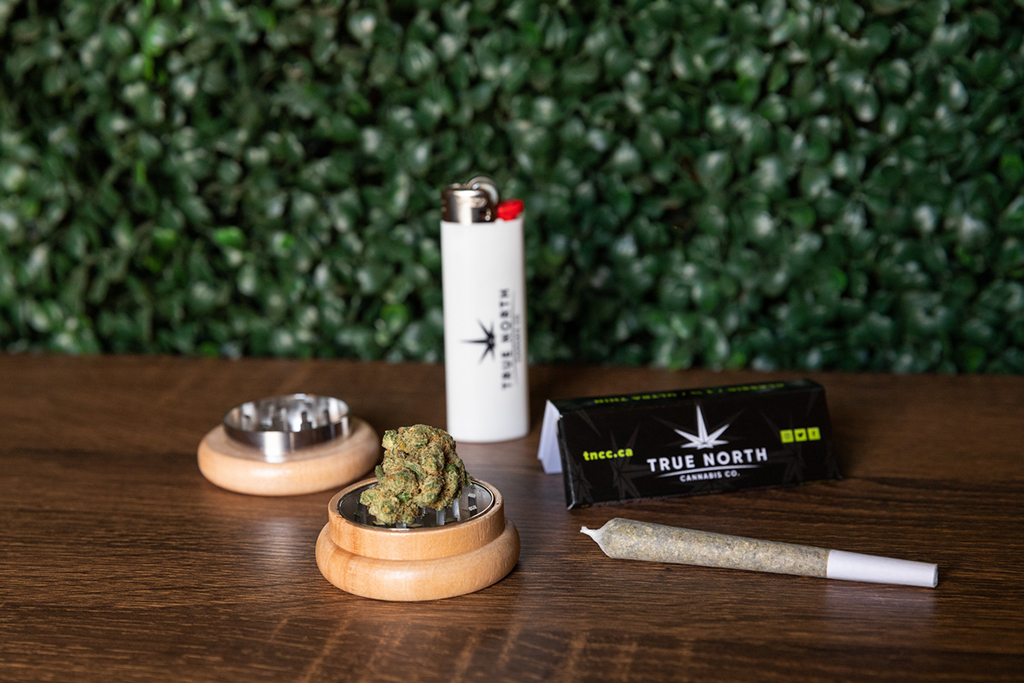 True North Cannabis Co. branded lighter and rolling papers next to a joint