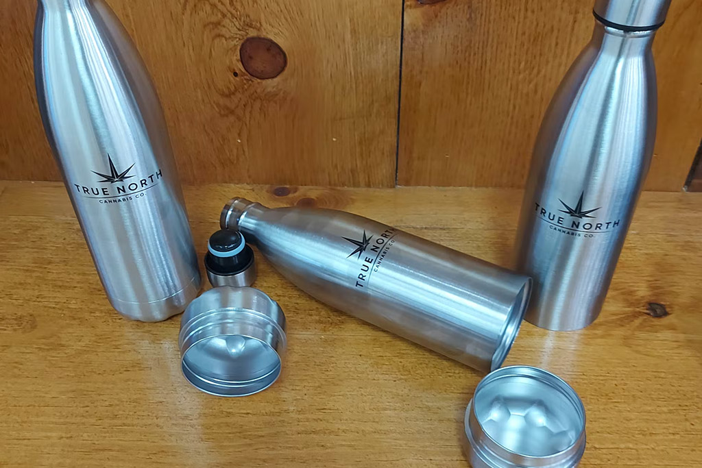A silver water bottle with a stash container from True North Cannabis Co. 