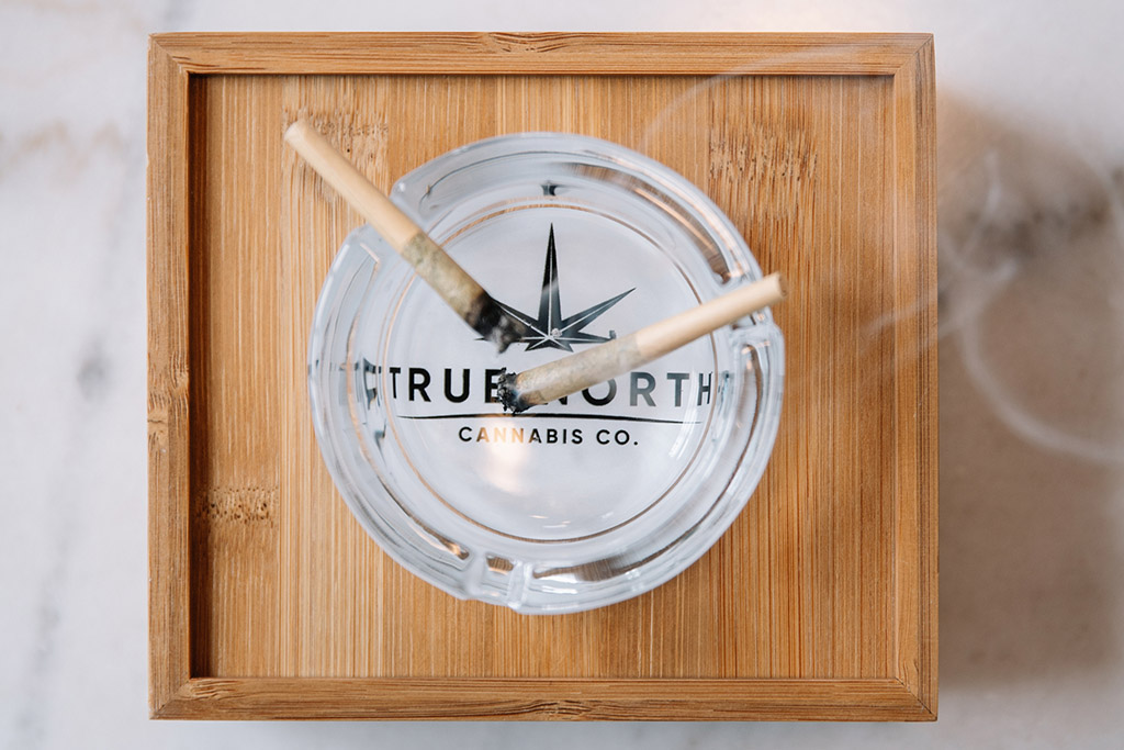 a True North Cannabis Co. ash tray holding two lit joints