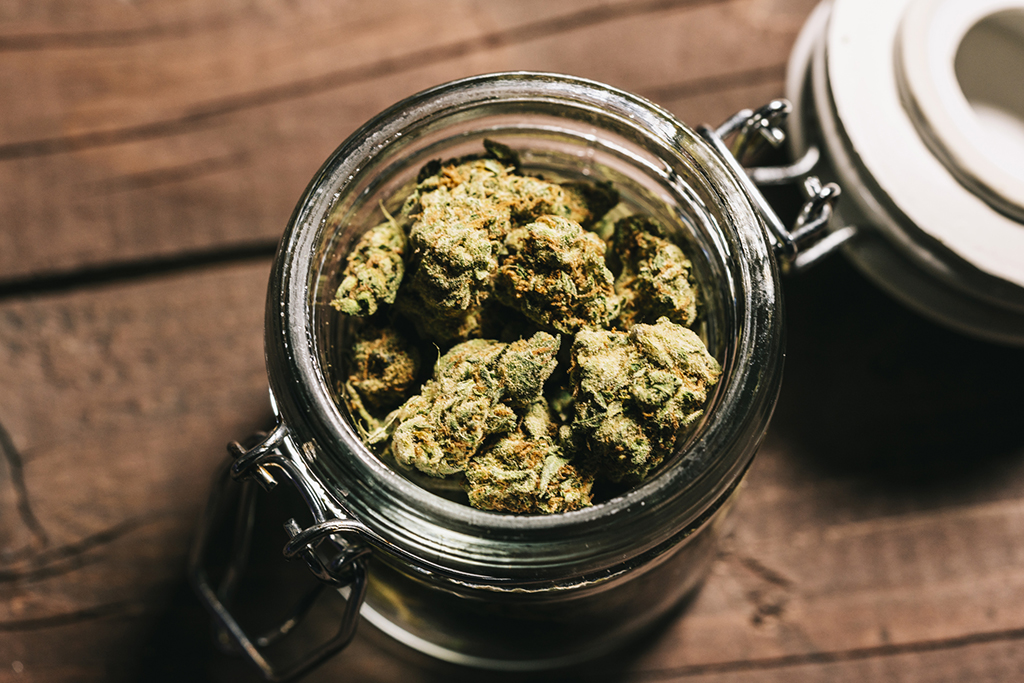 weed stored in a mason jar with the lid open