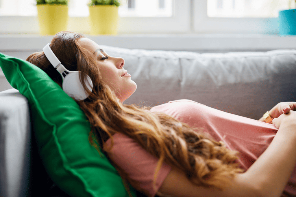 A person lying down while listening to the best Spotify playlists when high