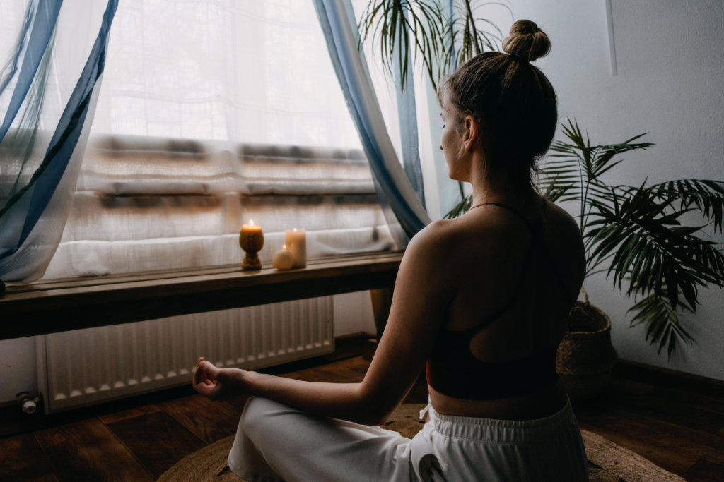  a woman meditating in her living room