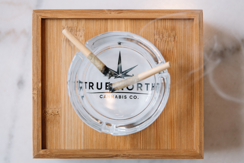 Two pre-rolls lit up on a True North Cannabis Co. ashtray 