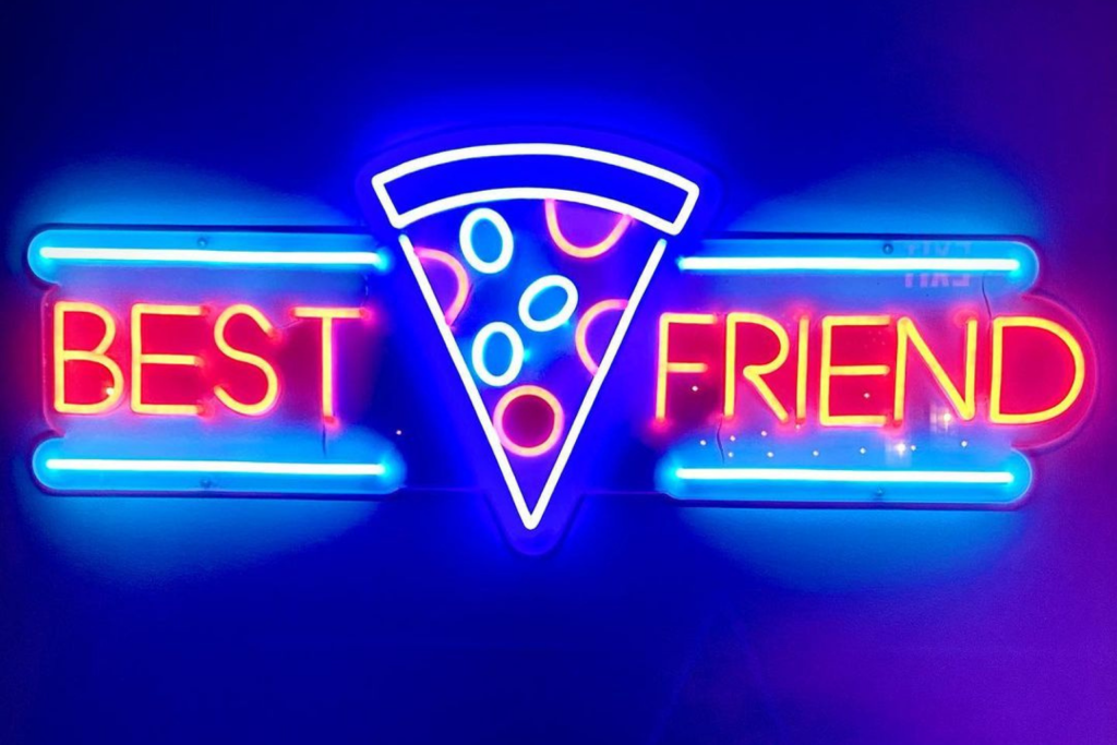 A neon sign at Best Friend Pizza