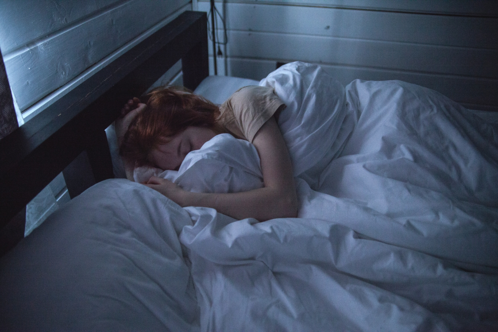 A woman sleeping in her bed
