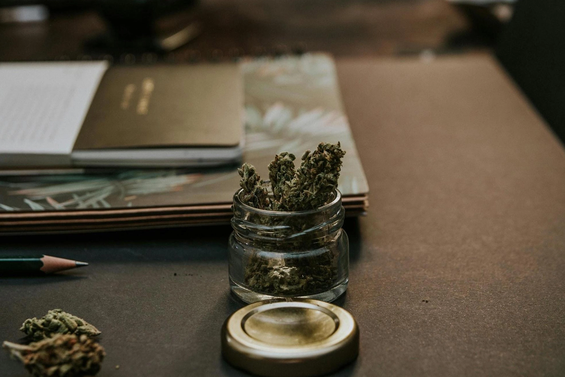 Cannabis buds in a glass container, showcasing proper storage.