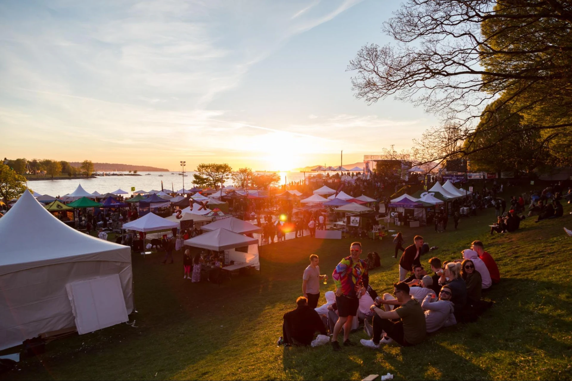 A group of people at a festival at dusk.